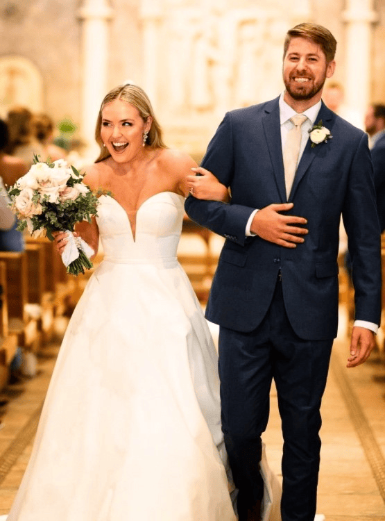 Young married couple walking down the aisle.
