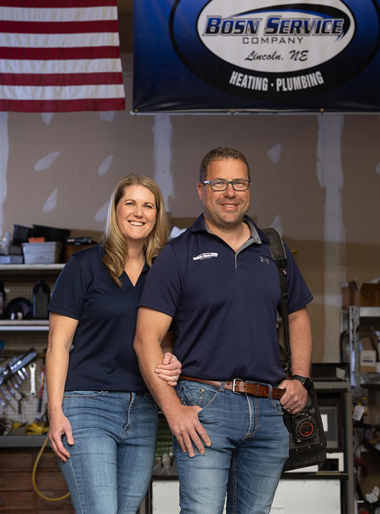 Photo of Reggie Bosn and his wife in their shop, owners of Bosn Heating & Plumbing