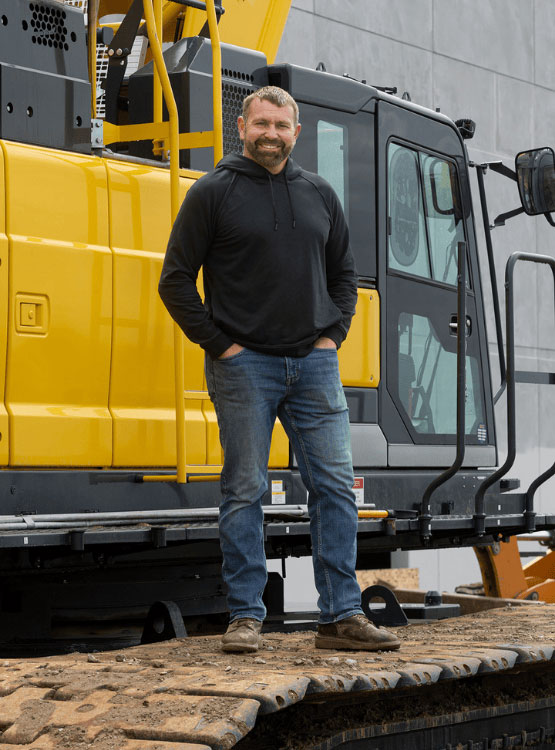 Cornhusker Bank business partner in front of construction equipment.