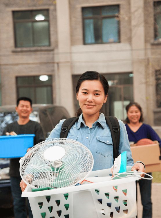 Female teenager moving into college dorm with her parents.