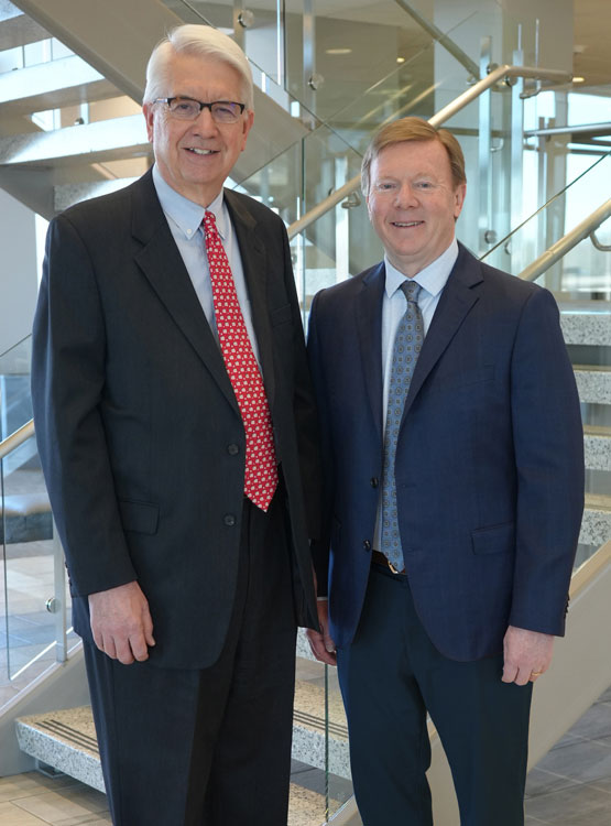 Barry Lockard and John Dittman in front of the lobby staircase.