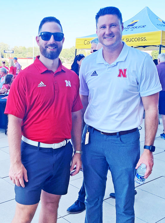 Staff pose for a photo at our Tailgate event on the patio.